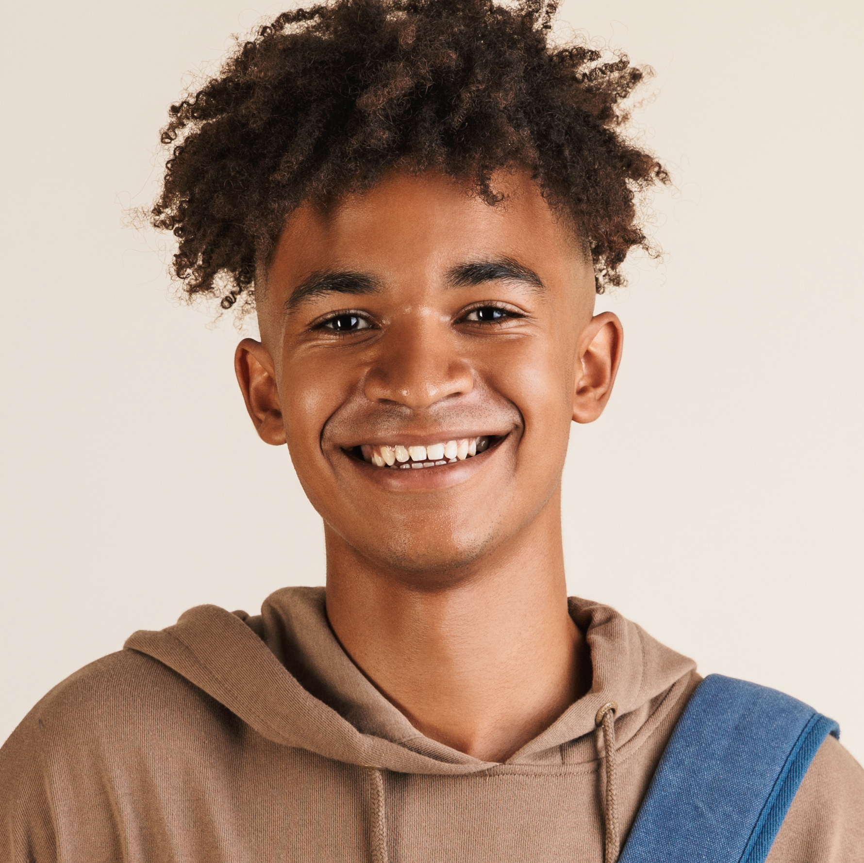 Portrait of a smiling young afro american man allied health assistant dressed in hoodie carrying backpack isolated, holding books